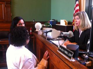 Judge Kelly O'Neill Levy discusses a case with her law clerk and resource coordinator.