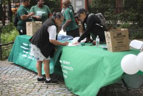 Harlem resource fair photo of staff helping community member
