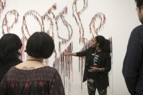 artist/facilitator describing art work on the wall to the group, Project Reset at the New Museum