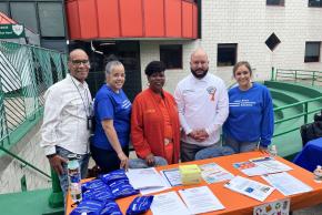 Bronx HOPE team poses with Councilmember Rafael Salamanca and Bronx District Attorney Darcel Clark at harm reduction table.
