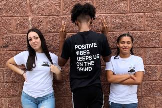Three teens wear INTRO shirts