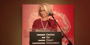 Judge Janet DiFiore speaking at a podium with the Center for Court Innovation logo